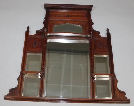 An Edwardian walnut stained over mantel mirror