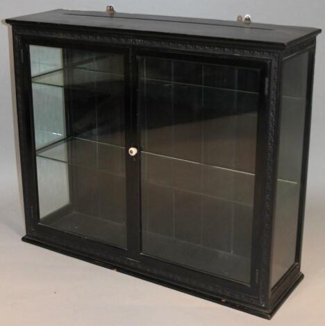 A 19thC ebonised hanging display cabinet