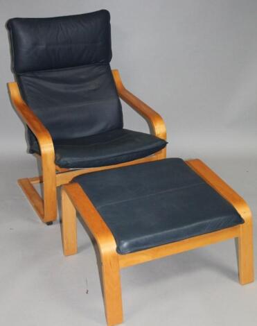 A modern beech framed cantilever armchair and footstool