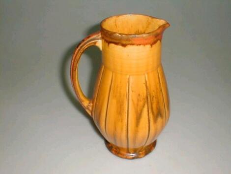 A Woods pottery jug, of baluster form, with a reeded neck and fluted body,