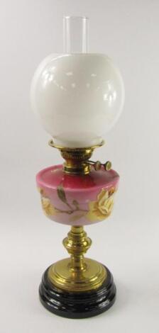 A late 19thC brass and pink opaline glass oil lamp