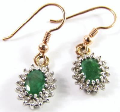 A pair of emerald and diamond oval cluster earrings