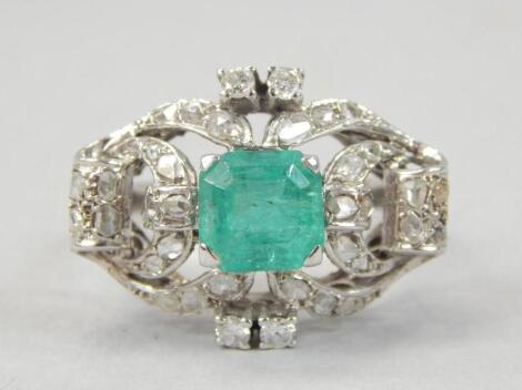 A diamond chip and emerald green stone ring