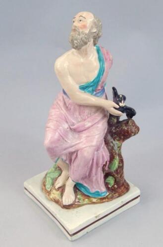 An early 19thC pearl ware figure of gentleman aside raven