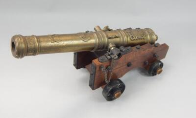 A brass finish table cannon