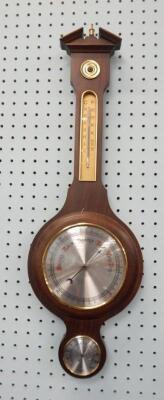 A modern mahogany finish two dial barometer