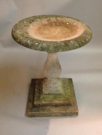 A composition stone bird bath