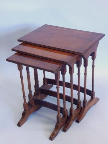 A nest of three yew veneered and ebony strung tables