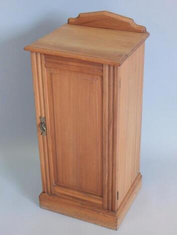 A stripped Victorian walnut bedside cabinet