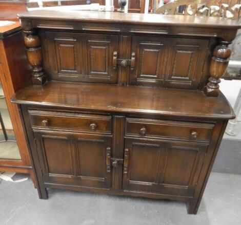 An Ercol type oak court cupboard