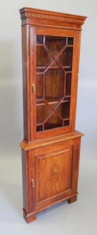 An Eastern hardwood and brass inlaid standing corner cabinet