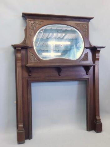 An Edwardian walnut fire surround