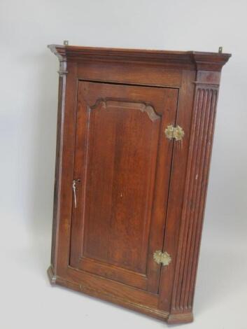 A George III oak corner cabinet