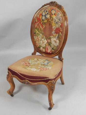 A Victorian walnut nursing chair