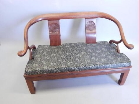 An Oriental hardwood sofa