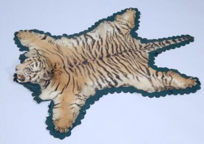 A taxidermied tiger cub skin rug