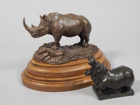 20thC School. A bronze resin figure of a Rhino on a stepped mahogany base
