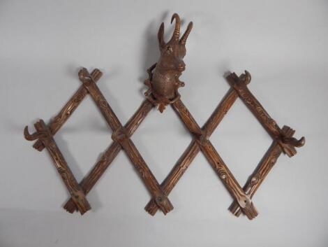 A Black Forest linden wood carved coat rack