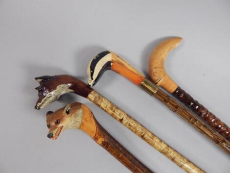 A collection of four late 20thC walking sticks