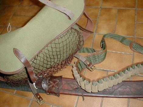 A Game bag, cartridge bag, 25 round 12 bore cartridge belt and a machete sheath