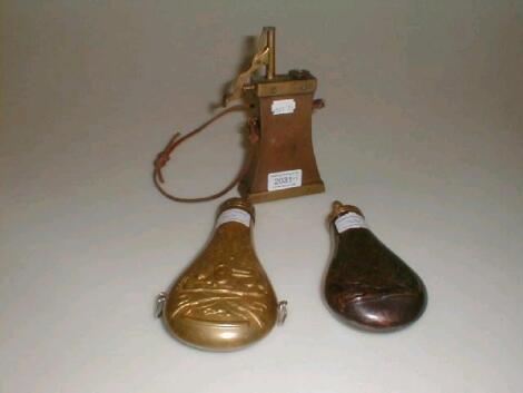 Three brass and copper powder flasks £40-60