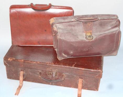 An early 20thC brown pressed leather crocodile style travel case