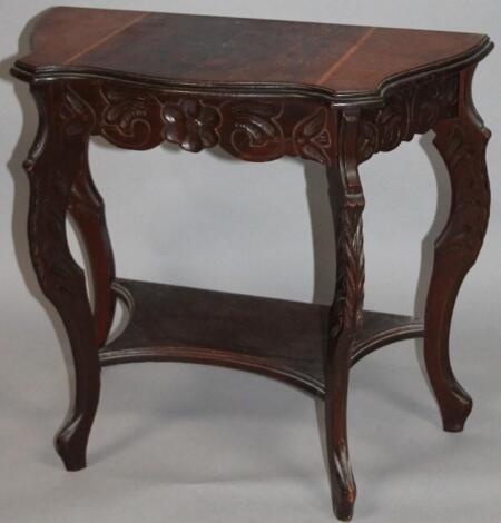 An Edwardian mahogany and walnut side table