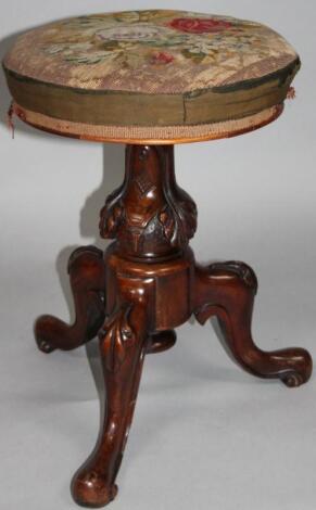 A Victorian walnut framed piano stool