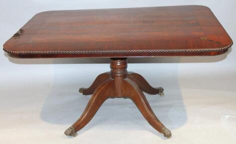 A Regency flame mahogany ebonised and metal inlaid supper table