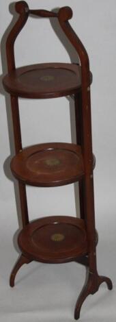 An Edwardian mahogany boxwood strung and painted three tier cake stand