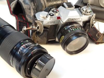 A Canon AV-1 camera with lens - 2