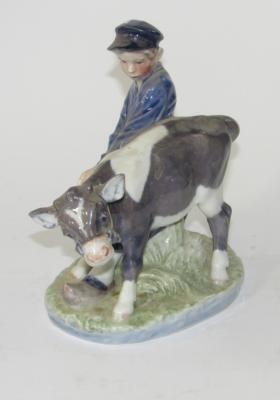 A Royal Copenhagen figure group of a young cow herder