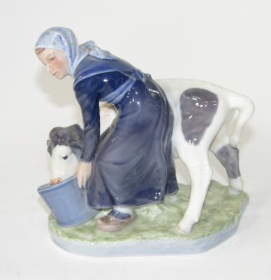 A Royal Copenhagen figure group of a young milk maid