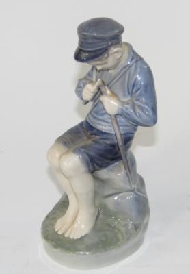 A Royal Copenhagen figure of a young seated boy