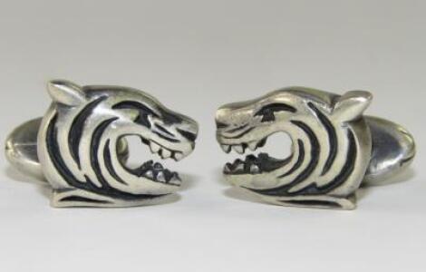 A pair of cufflinks with Leicester Tigers' Tiger's head motifs.