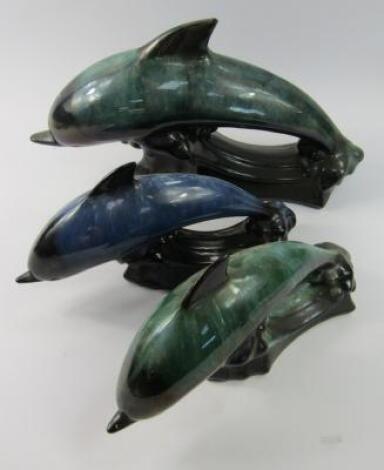 Three Blue Mountain Pottery dolphin model figures.