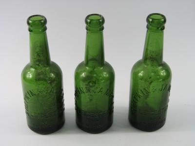 A Simpkin and James green glass bottle