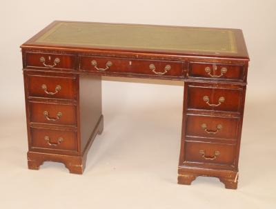 A reproduction mahogany pedestal desk