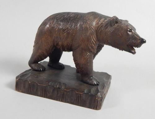 A 20thC Black Forest linden wood carving in the form of a bear