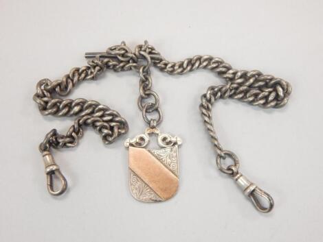 A silver watch chain and shield fob