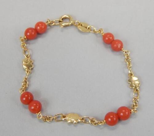 An 18ct gold coral christening bracelet