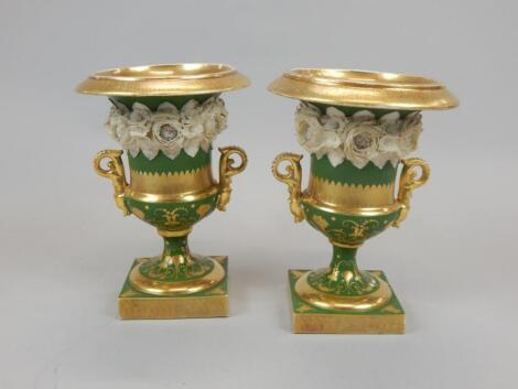 A pair of 19thC porcelain two handled urns