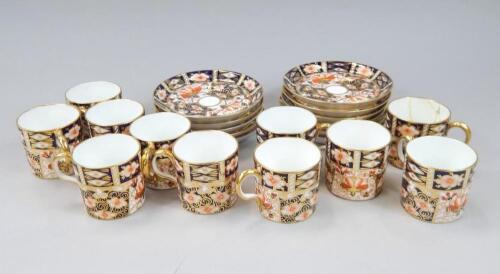 A collection of Royal Crown Derby coffee cans and saucers