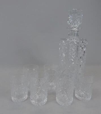 A cut glass decanter and various small cut glass tumblers