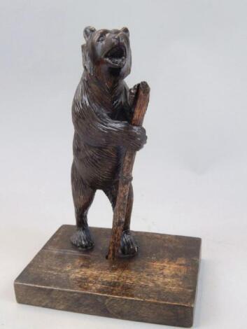 A hardwood Black Forest standing figure of a bear holding staff