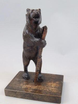 A hardwood Black Forest standing figure of a bear holding staff