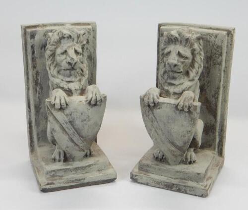 A pair of composition heraldic lion book ends