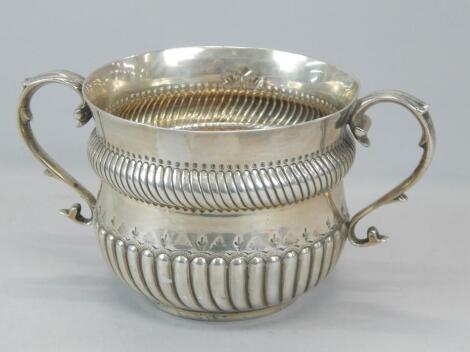 An Edwardian silver two handled sugar bowl or porringer