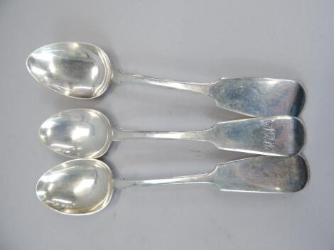 An associated set of three 19thC silver Fiddle pattern table spoons.