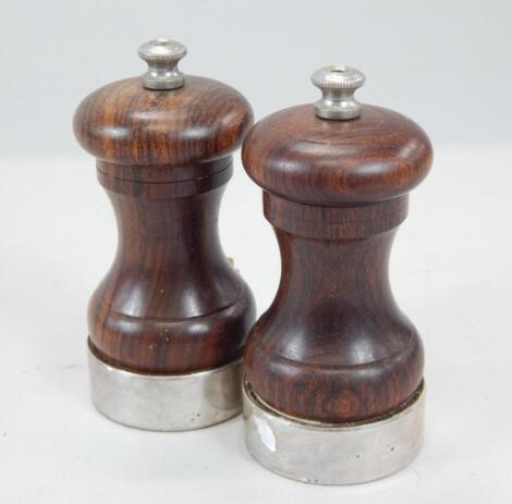 A turned hardwood and silver mounted pepper and sugar grinder